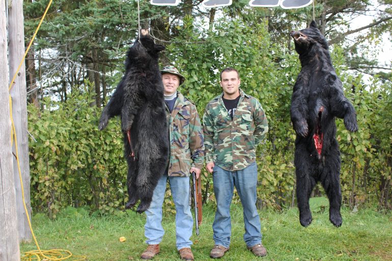 Father and son bear hunting partners with trophy bear at Foggy Mountain Guide Service