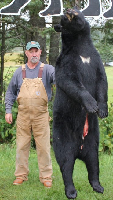 Black bear hunter with his trophy 