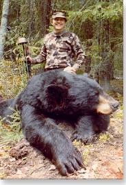 Bowhunter with his bear for the Pope and Young record book