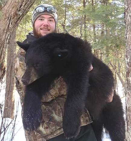 Brandon Bishop with yearling black bear