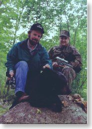 Tom Fegely looking at bear taken by hunter Chris Dolnack Tom Fegely (L), outdoor writer from Pennsylvania, looking at the bear taken by hunter Chris Dolnack (R) of the National Shooting Sports Foundation